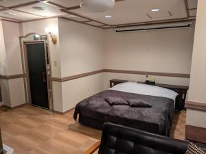 a bedroom with a bed and a couch in it at Hotel WILL Kashiwa in Kashiwa +21 photos