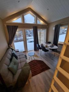 a living room with a couch and a table at Sjöställe Gudö in Vendelsö