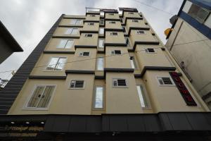 a tall building with windows on the side of it at Golden Comforts Banglore in Bangalore