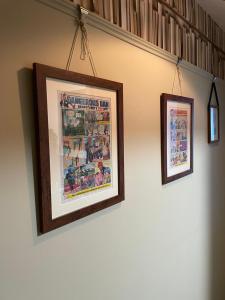 two framed pictures are hanging on a wall at Oakwood in Fleet
