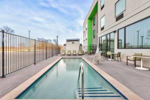 a swimming pool in the middle of a building at Wyndham Garden Anna in Anna