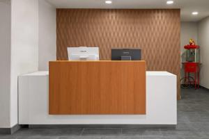 a reception desk with two computers on top of it at Wingate by Wyndham Los Alamos in Los Alamos