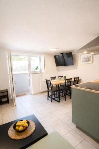 a kitchen and dining room with a table with bananas at Apartma Licko in Domžale +3 photos