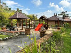 a playground with a slide and a gazebo at Katiliya Park Villa in Mae Chan