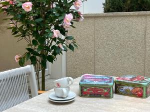 a table with a cup of coffee and a box of roses at SL Hotel Myeongdong in Seoul