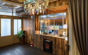 a lobby with a fireplace and a chandelier at Browndot Hotel Daegu Exco branch in Daegu