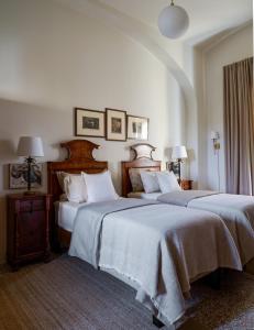 a hotel room with two beds and two lamps at La Giardina Guest House in Chieri +61 photos