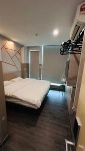 a bedroom with a bed and a television in it at C&CDreamland hotel in Ipoh