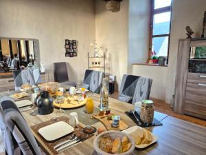 a dining room table with food on top of it at Manoir de la coudre in Changé