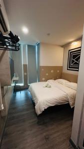 a hotel room with two beds and a tv at C&CDreamland hotel in Ipoh