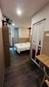 a bedroom with a bed and a large mirror at C&CDreamland hotel in Ipoh