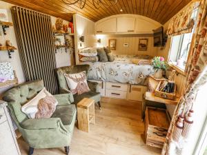 a bedroom with a bed and a bed and chairs at Twit Twoo Shepherds Hut in Louth