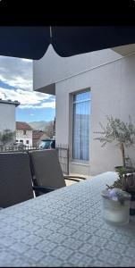 a white table with a potted plant on a balcony at Sobe Ivan-Popić in Međugorje