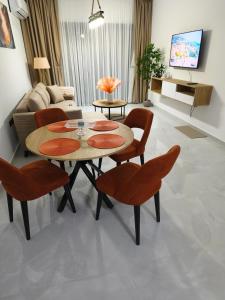 a living room with a table and chairs and a couch at Caesar Resort, Epictetus,Iskele, North Cyprus in Iskele