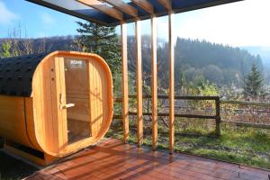 a wooden cabin on a deck with a view at UplandParcs Sauerland in Winterberg +28 photos