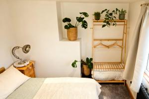 a bedroom with potted plants and a bed at Lush Rooms Bedminster in Bristol
