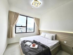 a bedroom with a bed with a teddy bear on it at Lloyd's Daily Suites - SOHO Residence, Bui Vien Walking Street, BenThanh Market & SG's Vibe in Ho Chi Minh City