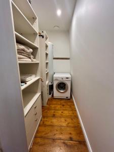 a walk in closet with a washing machine in it at Maison de campagne en plein centre de Senlis in Senlis