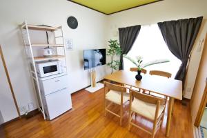 a kitchen and dining room with a table and chairs at カラハーイもとぶ 碧 in Motobu +45 photos