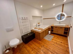 a bathroom with a toilet and a sink and a mirror at Maison de campagne en plein centre de Senlis in Senlis +9 photos