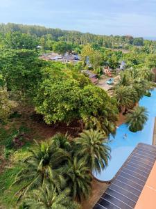 an aerial view of a resort with palm trees and a pool at Cozy apartment with a sea view in Ban Bo Sai Klang
