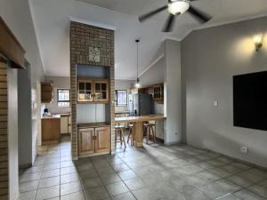 a large kitchen with a brick wall at Happy Holiday Lodge in Meer en See