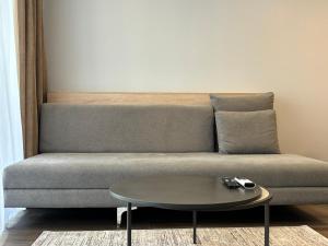 a living room with a couch and a table at Premier Hotel Miskolc in Miskolc