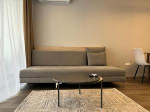 a living room with a couch and a table at Premier Hotel Miskolc in Miskolc