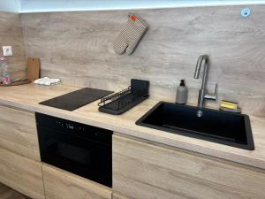 a kitchen counter with a sink and aaucet at Premier Hotel Miskolc in Miskolc +32 photos