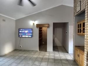 a living room with a tv on the wall at Happy Holiday Lodge in Meer en See