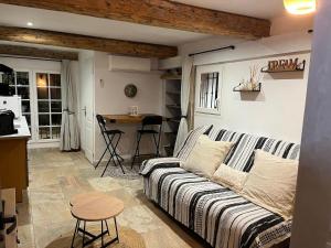 a living room with a couch and a table at Studio avec double terrasse Roquefort les Pins in Roquefort-les-Pins