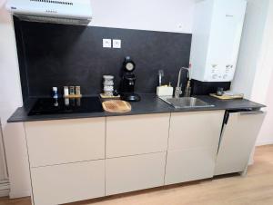 a kitchen with a sink and a counter top at Ma Casa in Boulogne-sur-Mer