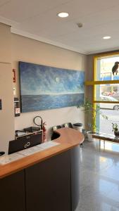 a kitchen with a counter and a painting on the wall at Hotel Blauet by Bossh! Hotels in El Prat de Llobregat