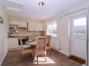 a kitchen and dining room with a table and chairs at Country Cottage in Brecon