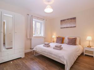 a bedroom with a bed with two towels on it at Country Cottage in Brecon