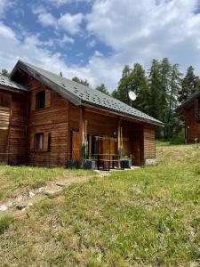 an old log house with its door open at chalet mitoyen en duplex in La Joue du Loup