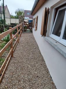 a walkway outside of a house with a fence at Maisonnette étape équestre in Nogent-lʼArtaud +1 photo
