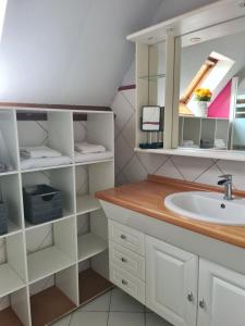 a bathroom with a sink and a mirror at L'épi de blé in Saint-Astier +32 photos