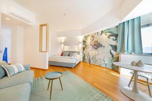 a living room with a couch and a bed at Mercure Olbia Hotel e Spa in Olbia +77 photos