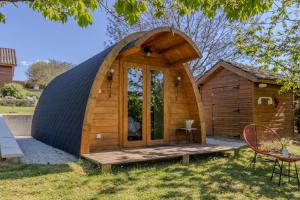 a dome house with a deck in the yard at Chambre d'Hôtes La Guignette in Saint-Cybranet