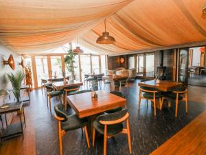 a restaurant with tables and chairs in a room at Rose Apartment - Gower in Swansea +39 photos
