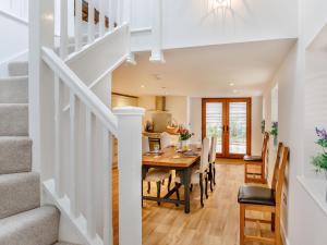 a dining room and kitchen with a table and chairs at The Granary - Uk38980 in Llandyssil +13 photos