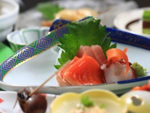 a plate of food with sushi on a table at Eshin no Sato Yasuragisou in Joetsu