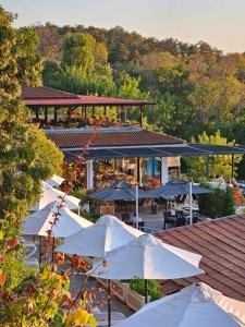 a group of white umbrellas in front of a building at Blue Marina Sunset in Sozopol