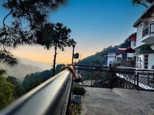 a view of the mountains from a balcony of a building at Tara Luxury Homes in Solan
