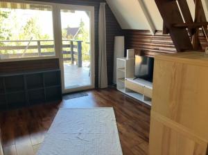 a living room with a large sliding glass door at Búj-Lak Dunakanyar in Tahitótfalu