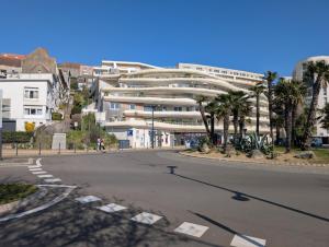 a building on a street with palm trees in front at Ma Casa in Boulogne-sur-Mer