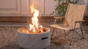 a fire pit sitting next to a chair and a chair at gyeongju planb pet pension in Gyeongju