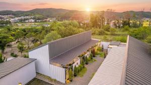 an overhead view of a building with a sunset in the background at gyeongju planb pet pension in Gyeongju