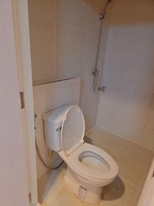 a white toilet in a bathroom with a shower at Hugg daily airport 1 in Samutprakarn